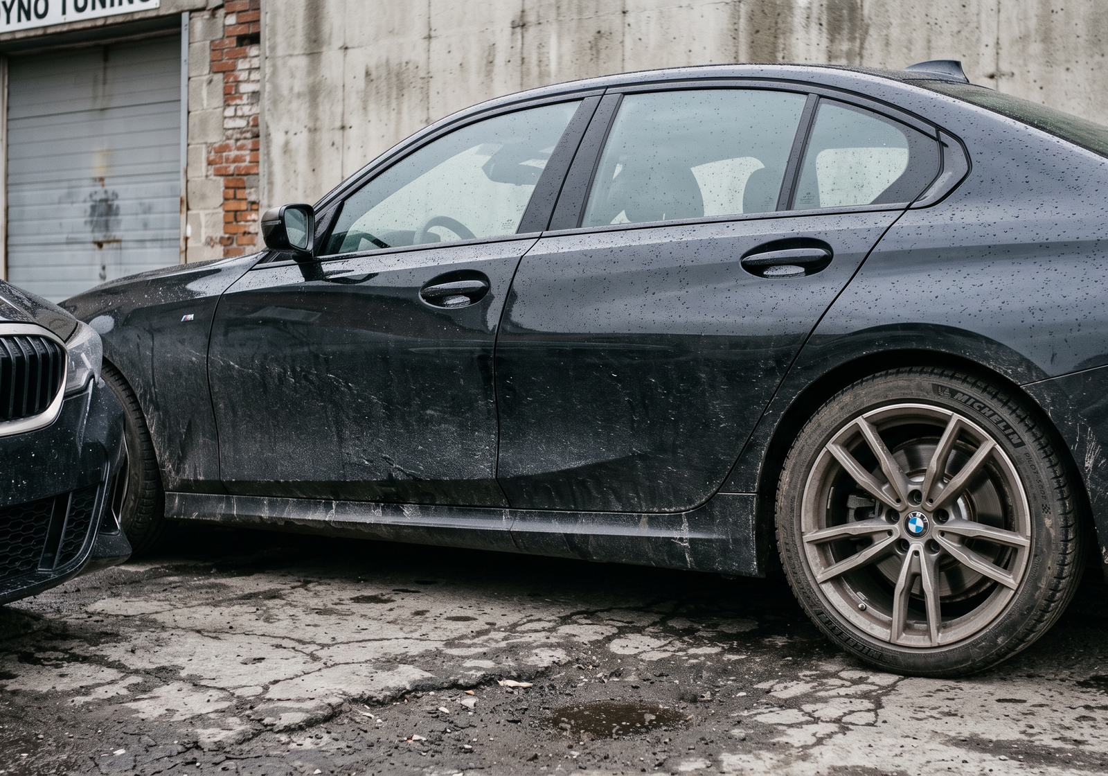 Illustration: grimy black BMW M340i sedan outside a small dyno workshop on a wet overcast day