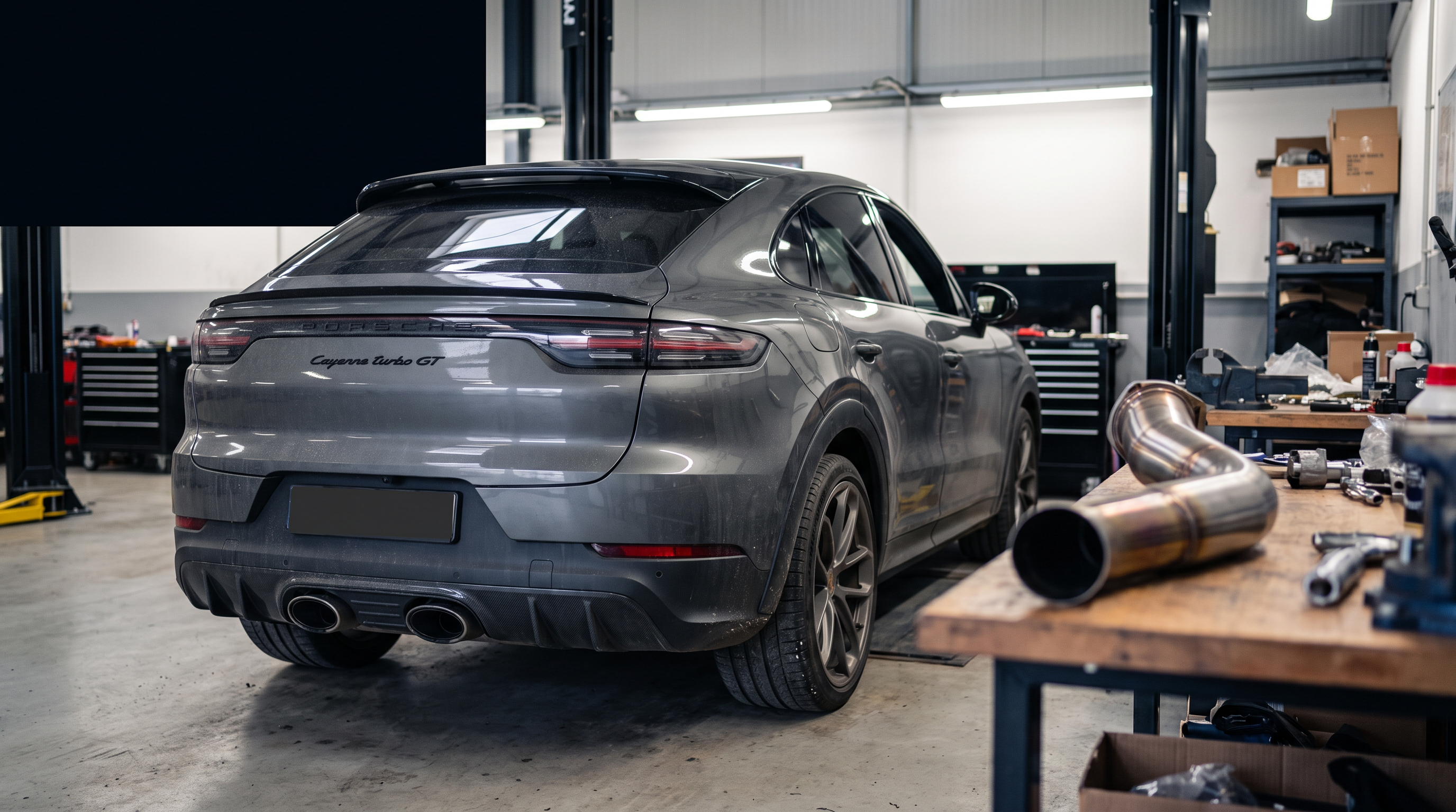 Porsche Cayenne Turbo GT in a workshop with exhaust and downpipe components for a buyer guide