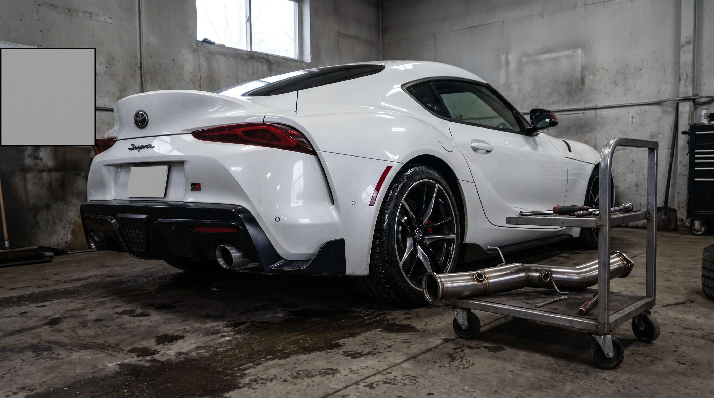 Illustration: white Toyota GR Supra A90-style coupe in a workshop with a downpipe section for a fitment and Stage 2 tuning guide