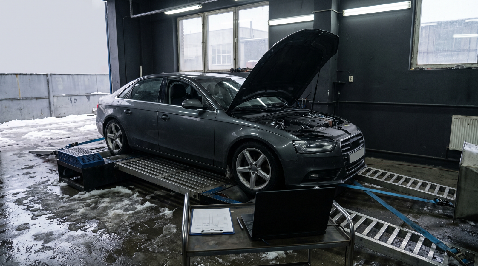 Generic sport sedan strapped to a chassis dyno in a Quebec tuning workshop for a dyno tuning prices and booking checklist